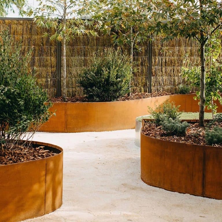 Clean curved garden edging separating planting from a gravel path in Adelaide
